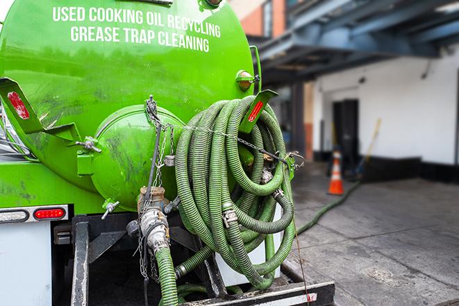 a vacuum truck pumping out a large underground grease trap in Chicopee, MA